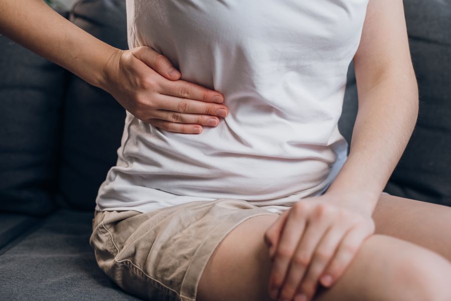 hand placed on abdomen side due to pain 